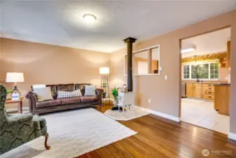 Thoughtful architectural cutouts create an airy flow between the kitchen and living room, making gatherings effortless.