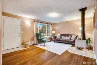 Warm hardwood floors and abundant natural light make this living room a welcoming centerpiece. Let's check out the rest of the house.