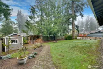 The back yard is private and lushly landscaped with a garden shed and room to roam—your own slice of paradise.