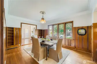 Dining Room retains many original features.  Warm wood paneling with 'don't-miss' hidden storage. Close the paneling doors and the shelving in the wall simply disappears!
