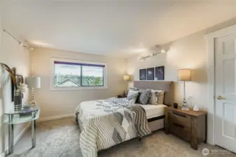 Primary Bedroom upstairs is at the front of the house with a lovely outlook from the window.