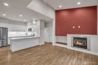 Living room with high ceilings and cozy gas fireplace.