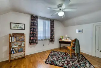 Upstairs bedroom with hardwood floors and walk in closet.