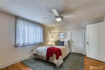 Upstairs bedroom with original oak floors is spacious and bright.