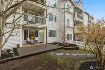 Area photo of the yard, footpath leads to garage, last door on the right
