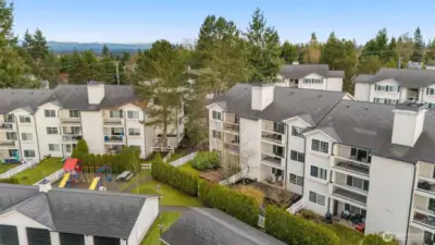 The 2nd fenced area is the yard and the garage roof on the right is the detached garage that comes with the unit