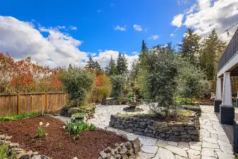 European style back yard with extensive stonework and fountain.