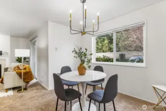 The dining area seamlessly connects the kitchen and living room, offering a perfect space for both casual meals and formal gatherings.