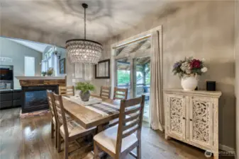 Another view of the dining room. Notice the two-sided fireplace and the beautiful smoked glass chandelier.