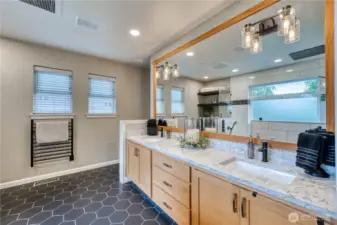 Dual vanities, wood wrapped mirror and the added luxury of a heated towel rack.