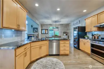 Kitchen with stainless appliances has nice flow to the dining room and family room.