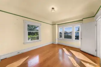 Looking to the west in living room. Pocket doors provide privacy. Front porch to right.