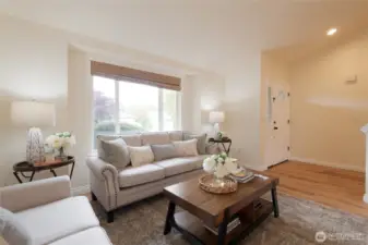 The welcoming entryway immediately sets the tone with light-filled space and vaulted ceilings above the living room. It’s the perfect first impression for guests and homeowners alike.