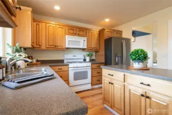 The heart of the home is this open, well-appointed kitchen. A large island, durable Corian counters, and a walk-in pantry combine style with functionality.