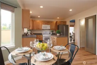 The kitchen eating nook with bay window is a cheerful spot to start and end your day. The large walk-in pantry is a true highlight, offering ample storage space for dry goods, small appliances, and kitchen essentials. Designed to keep everything organized and within reach, it helps maintain a clutter-free and streamlined kitchen.