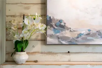 Stylish designer touches include a shiplap accent over the fireplace, complete with a convenient TV connection.