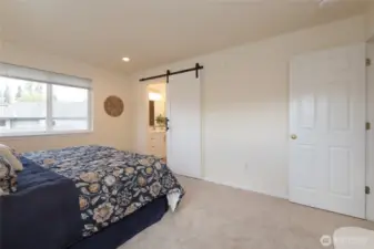 The primary bedroom enjoys a private EnSuite with Barn Door and walk in closet. Plenty of room here for your bedroom set, even with this King Sized bed.