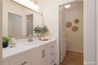 The beautifully updated Primary EnSuite enjoys custom cabinetry, a walk-in closet, separate W/C and easy care LVP flooring.