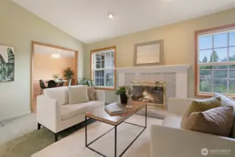 A classic marble fireplace with detailed mantel serves as the elegant focal point.