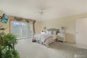 Welcome to the spacious and serene primary suite—your private retreat with peaceful lake views. Enjoy direct access to a secluded deck, perfect for morning coffee or evening unwinding. The generously sized bedroom features plush carpeting, soothing tones, and ample natural light. An en suite bath and an expansive walk-in closet complete the space, offering both comfort and convenience in a truly relaxing setting.