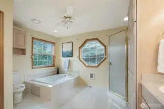 Glass-enclosed shower and oversized jetted soaking tub provide options for both quick refreshes and relaxing soaks.