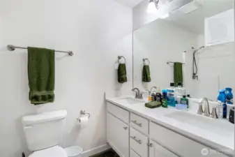 Bathroom with dual sinks off primary.