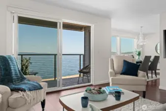 Generous great room with sliding glass door, offering access to private, covered deck