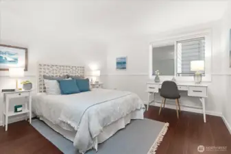 Sizable secondary bedroom can accommodate a queen or king-sized bed and desk or dresser, with fresh paint and warm luxury vinyl flooring