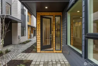 Step into a private courtyard entry framed by wood accents and bold contemporary design—inviting from the first look.