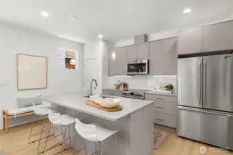 The open-concept layout creates a fluid connection between the kitchen and living spaces, ideal for entertaining.