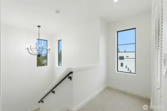 Stairway to upper level with plenty of natural light