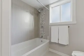 Soaking tub and shower to lower level bath