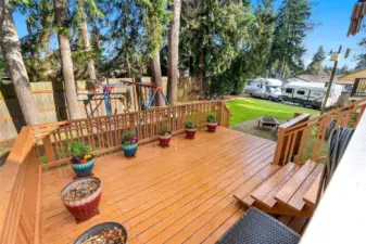 Wood deck adjacent to sun deck and back yard