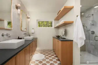 Primary bathroom with under-cabinet lighting, floating shelves and vessel sinks.