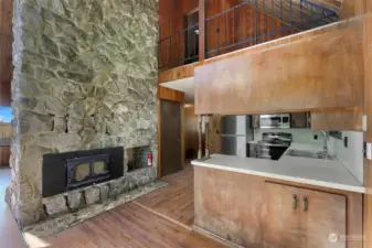 Fireplace shows from kitchen/ dining area through to the main living space.