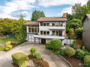 Greenery and a circular driveway front this home, one filled with ingenious architecture and accessible touches.