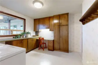 Laundry room has ample counter and cabinet space.