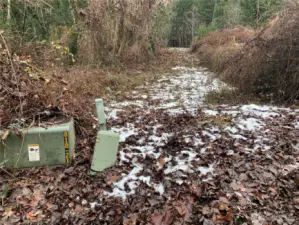 This is part of Lot 3, the property for sale. The SE property line runs along Graham Road. This is an alternate driveway access to the property and does not require an easement. Mason PUD#3 transformer is sitting on west corner of this property.