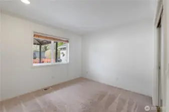 Guest bedroom offers views of the backyard and overlooks the deck.