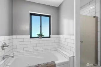 The bath has a large jetted tub and separate shower.
