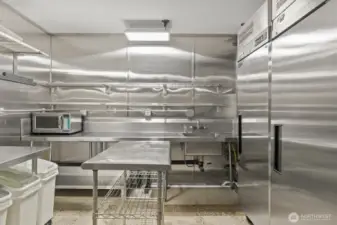 The side prep area has 2 commercial freezers and wash sink.
