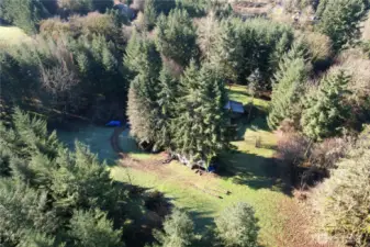 Aerial view of 40 acres with a home and barn. Country living while being close to La Center city limits. Easy I-5 access, plenty of wildlife with timber management in place, boarders Jenny Creek.