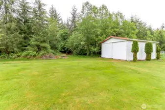 Metal shop sits at the front corner of the property.