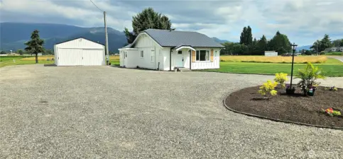 Amazing parking area for guests and toys! driveway. RV parking next to the shop as well as behind it. RV power plug is in and ready to go.
