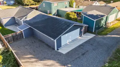 Extra parking to the the left of the garage for an RV or boat. Both sides have gates that open into the backyard.