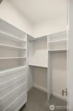 This thoughtfully designed walk-in closet offers ample shelving and hanging space to keep your wardrobe organized and accessible.Photos of home with similar layout, finishes & fixtures.