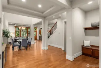 Ceiling drama and walls of windows capturing abundant natural light, grounded by sumptuous hardwoods.