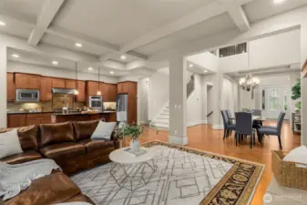 Thoughtful main floor plan has a gorgeous open great room design featuring island kitchen, large dining area, and comfortable living room with box beam ceilings and hardwoods throughout overlooking a protected greenbelt.