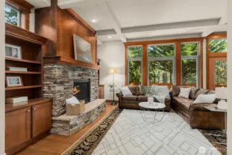 Natural light from expansive windows that frame serene views of a protected greenbelt.