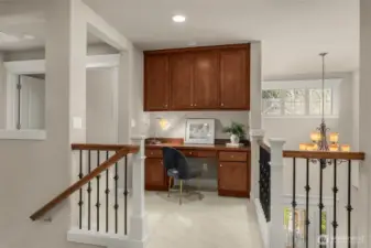 A dedicated space at the top landing provides a perfect place for focused study or creative projects.
